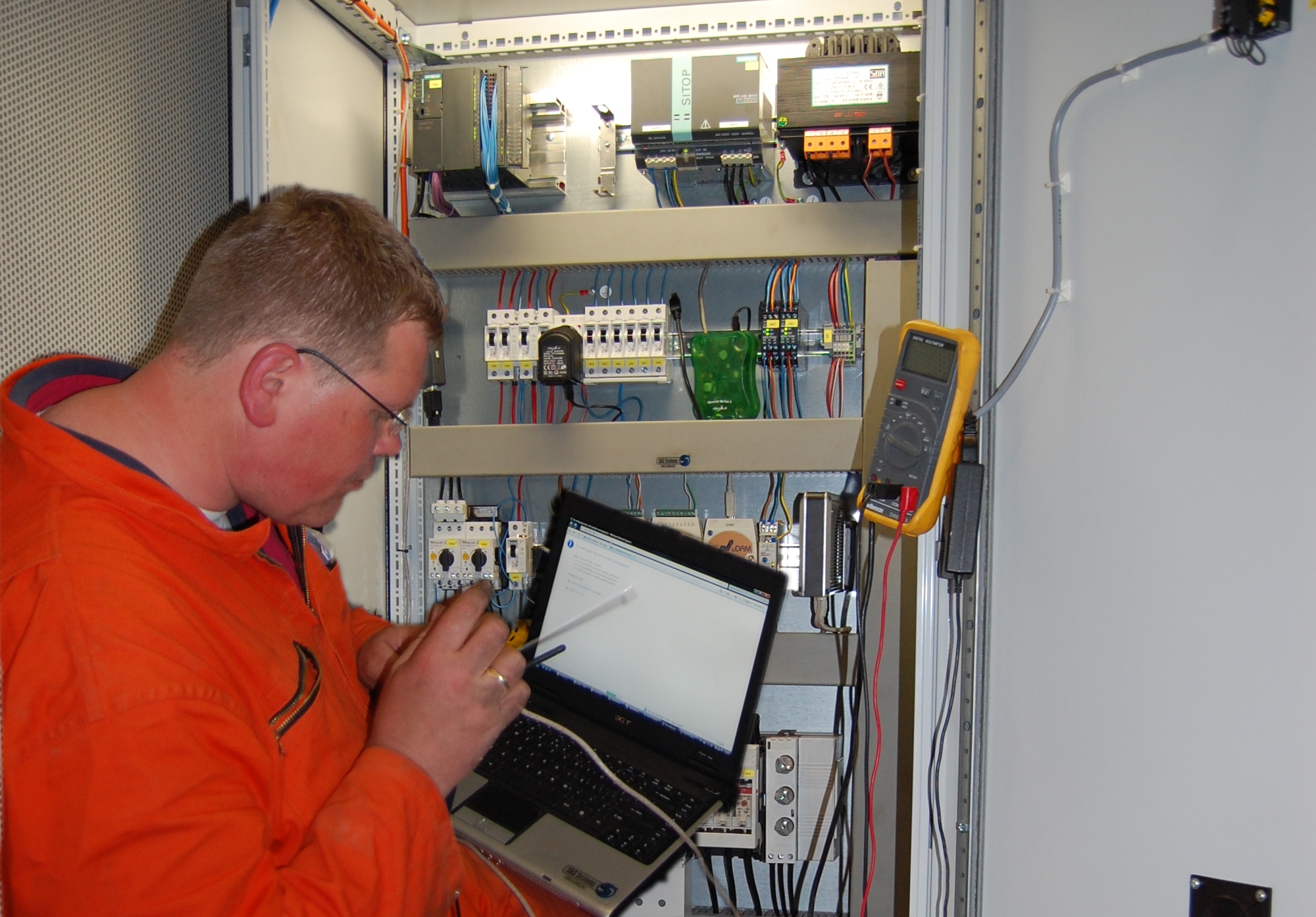 Engineer configureert een industriële besturingskast
